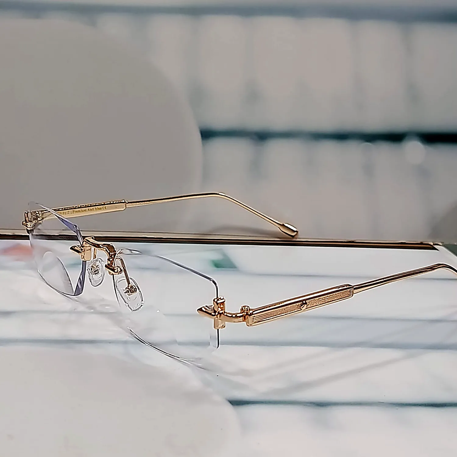 N-102 Elite Gold gold rimless reading glasses — angled view