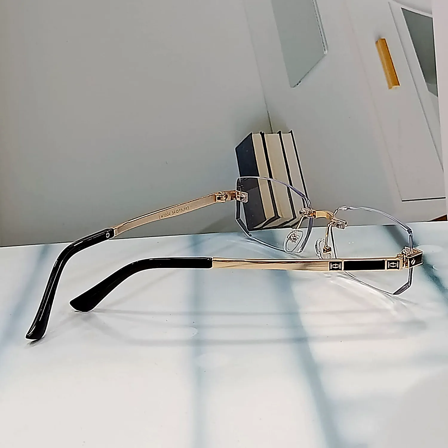 N-103 Regent Gold gold rimless reading glasses — side view with gold temple and black tip